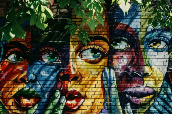 Vibrant mural showing diverse community with intertwined hands o