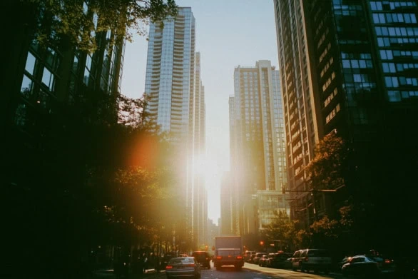 Bright Sunset Illuminates Tall Skyscrapers in Urban Cityscape Du