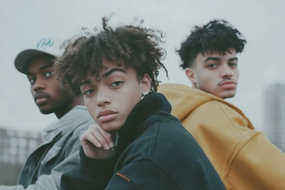 Three Young Adults Posing Together Outdoors in Urban Environment