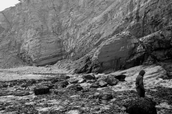 Black and White Coastal Scene with Figure