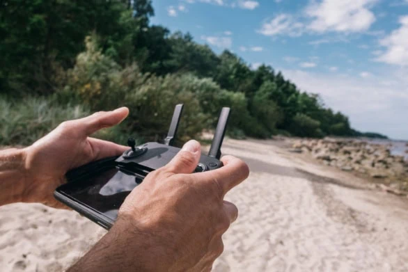 Drone Remote Control in Hands at a Seaside Location