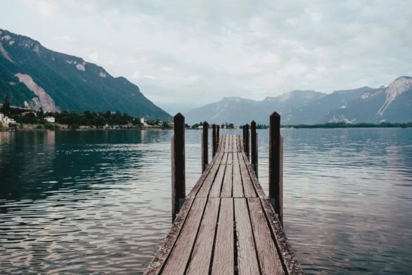 Scenic Wooden Pier on Lake Geneva with Mountain Views in the Ear
