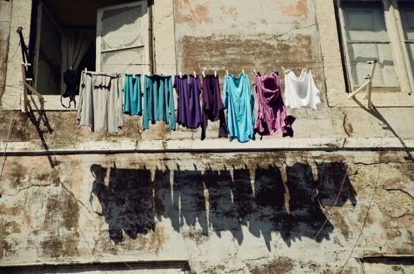 Hanging laundry against a vibrant wall in Portugal