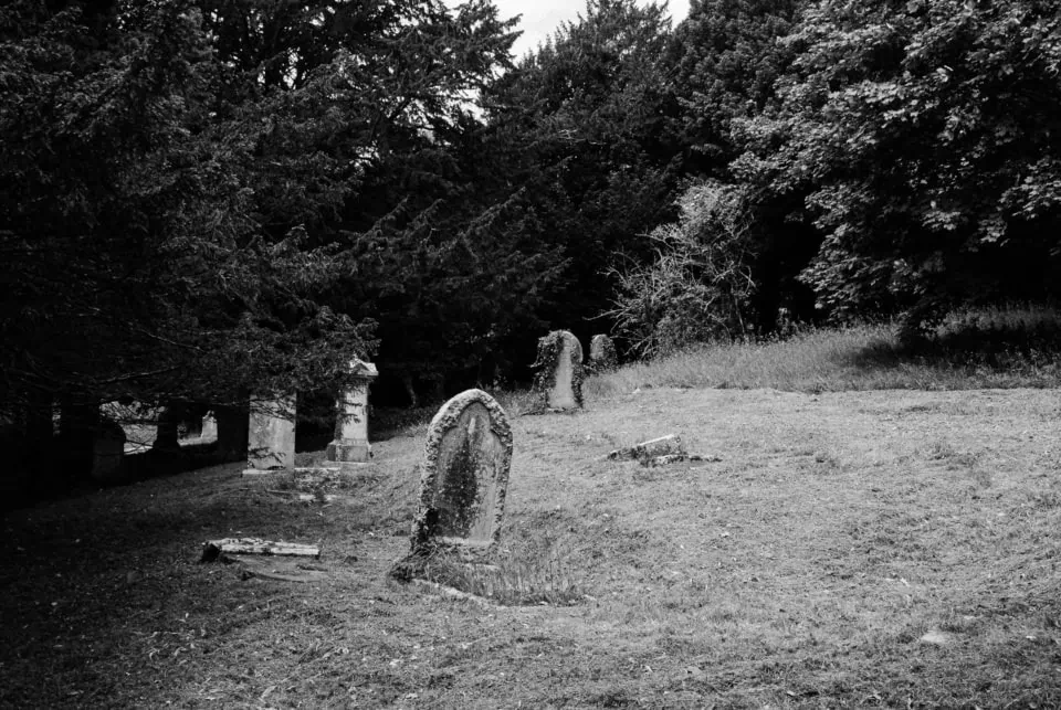Quiet graveyard in Penryn, Cornwall surrounded by trees