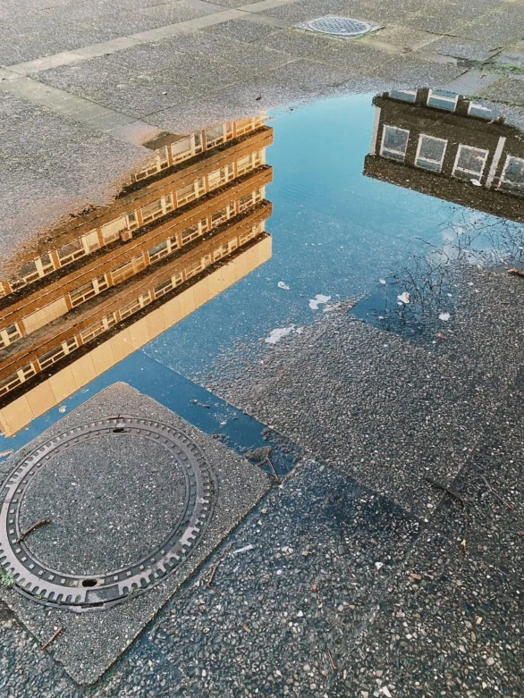Puddle Reflection of Urban Buildings