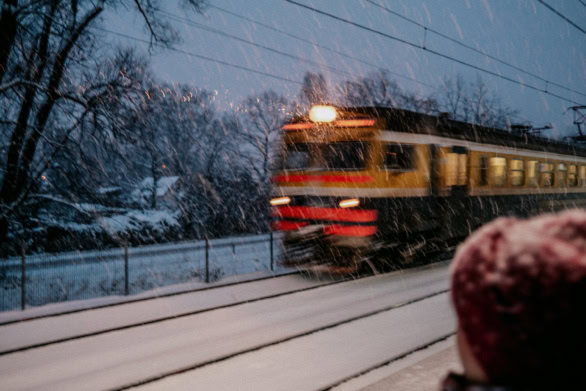 Train Pulling Away from the Platform During Heavy Snowfall