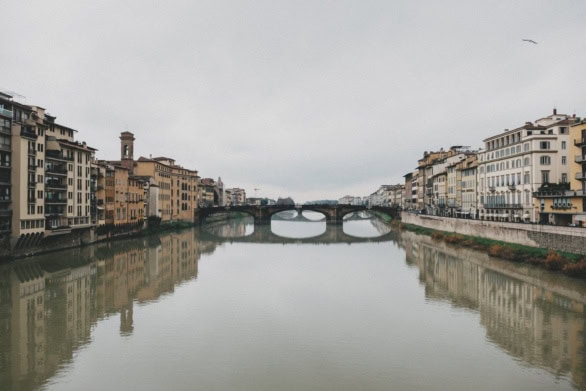 Florence cityscape reflected in the Arno River on an overcast da