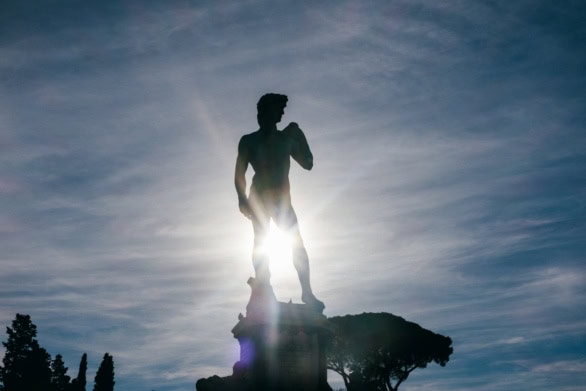 Silhouette of Michelangelo’s David statue against the sun in F